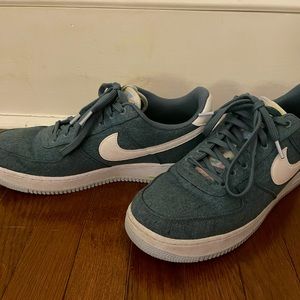 Green canvas Nike Air Force 1s.